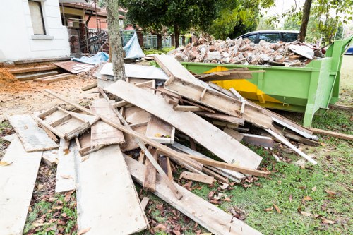Construction site with builders handling waste clearance